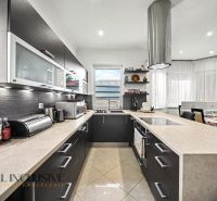 A spacious kitchen in a family house with modern equipment and a view of the garden.