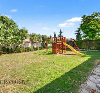 The garden of a family house in Kostolné Kračany with a playground and a basketball hoop.