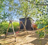 A playground near the cottage in Suchá nad Parnou with a swing and a slide.