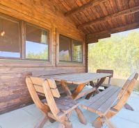 Wooden gazebo at the cottage in Suchá nad Parnou with benches and a table on the terrace.