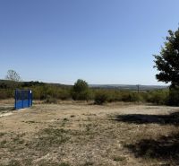 Agricultural and forest lands in Pezinok, Kučišdorfská Street, with a blue entrance gate.