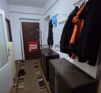 Hallway in a 4-room apartment with a coat rack and cabinets.