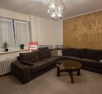 Living room in a 4-room apartment with a sofa and a glass table.
