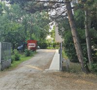 The gate and trees on Moyzesova Street in Pezinok in front of the 4-room apartment.