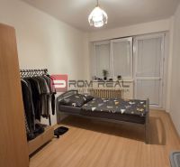 Minimalist bedroom with a bed, wardrobe, and wooden decor flooring in a 4-room apartment.