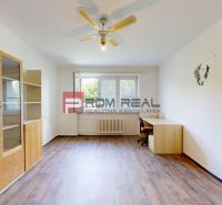 A spacious room with wooden floor decor, built-in cabinets, and a desk in a 4-room apartment.