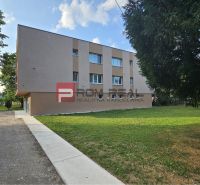 Apartment building on Moyzesova Street in Pezinok with an access walkway and parking spaces.