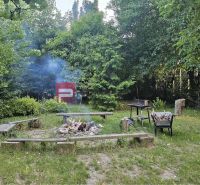 A peaceful garden with a fire pit and benches in a 4-room apartment on Moyzesova Street in Pezinok.