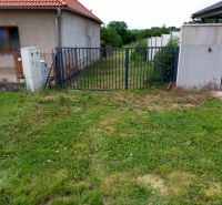 A grassy plot with fencing in Beladice suitable for living.