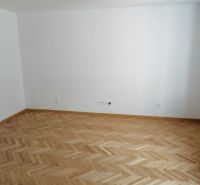 An empty room with wooden floor decor in a two-room apartment.