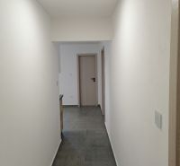 A corridor with tiles and white walls in a 2-room apartment.