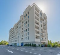 Residential building on Labutia Street in Bratislava, Petržalka, with sunlight in the background.
