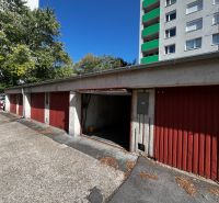 Row of garages on Hanulova Street in Dúbravka, Bratislava next to the apartment building.