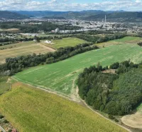 Agricultural and forest land in Žilina with a panoramic view of the surrounding mountains and the city.