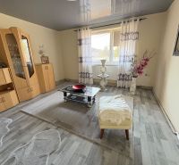 Living room of a family house with furniture and a wooden decor floor.