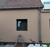 A family house in Krušovce with a brick roof, windows, and exterior decorations.