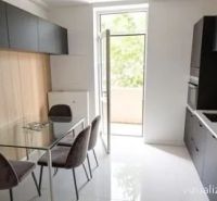 Kitchen in a 2-room apartment with a dining table and access to the balcony.