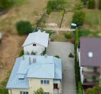 A family house on Topolianska Street in Michalovce with a garden and an adjacent building.