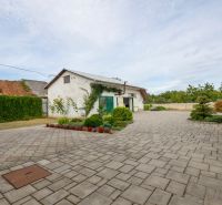 A family house on Topolianska Street in Michalovce with a paved yard and a neat hedge.