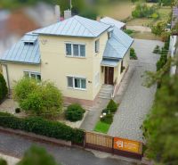 Family house on Topolianska Street in Michalovce, garden and paved walkway.