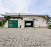 A garage at a family house on Topolianska Street in Michalovce with a car inside.