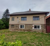 A family house in Drnava with a stone facade and a grassy garden in a fresh environment.