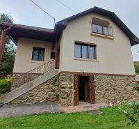 A family house in Drnava with a staircase, stone details, and greenery in the surroundings.