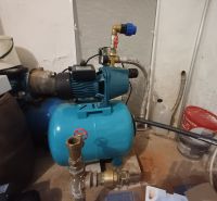 A water facility in the basement of a family house, surrounded by various equipment.