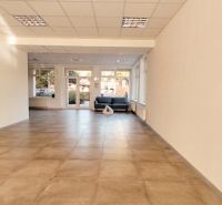 Spacious offices with tiled floors and large windows bring in natural light.