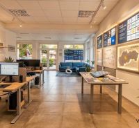 Offices with spacious layout, screens and information panels, floor with wooden decor.