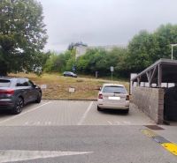 Parking lot at the Offices on Nad Plážou Street, Banská Bystrica with containers.