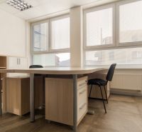 Offices with large windows, desks, and wood-patterned flooring.
