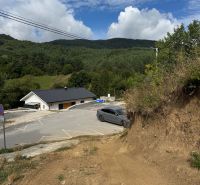 Plots - housing in Považská Bystrica with a view of wooded hills and a road.