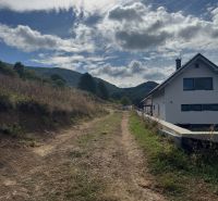 A country road leads to a house on the outskirts of Považská Bystrica, ideal for residential plots.