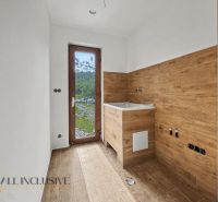 Interior of a family house with wooden decor and a view of the garden.