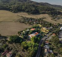 Aerial view of development plots in Slatinské Lazy surrounded by forests and meadows.