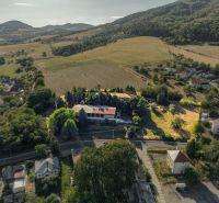Aerial view of development plots in Slatinské Lazy, surrounded by hilly landscape.