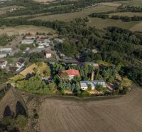 Aerial view of development plots in Slatinské Lazy surrounded by nature and buildings.