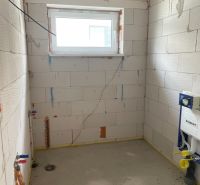 A bathroom under construction in a family house without a finished floor and tiles.