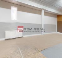 An empty office space with wood-patterned flooring and white walls.
