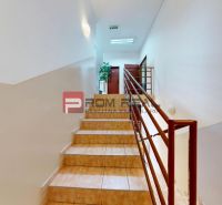 Staircase in Offices with brown tiles and railing.