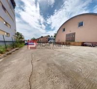 Parking lot at the offices on Elektrárenská Street, Bratislava III, with an arched building.