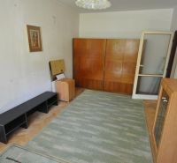 A room in a 3-room apartment with a floor featuring a wood decor and furniture.