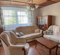 Living room in a family house with a wooden decor floor and comfortable furniture.