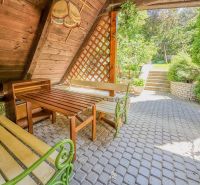 Terrace with a garden view, wooden benches in a family house in Sady nad Torysou.