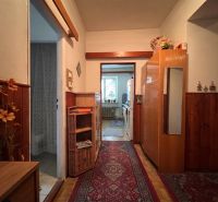 A hallway of a family house with rustic furniture elements and a wooden decor floor.
