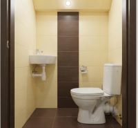 A toilet with a sink in a 3-room apartment with a simple design.