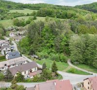 Aerial view of Turová with plots - housing, surrounded by greenery and houses.