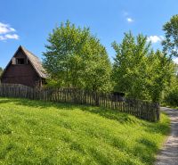Wooden cottage with a fence on a plot of land near the forest in Radôstka.