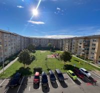 Apartment buildings on Palkovičova Street in Topoľčany with a parking lot and a playground.